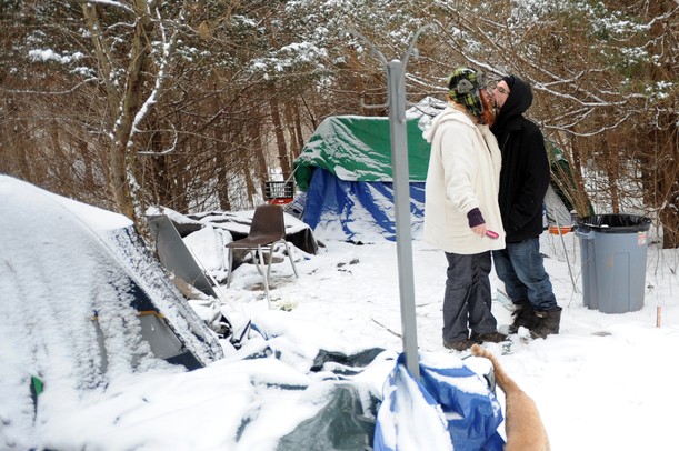 Alanna Gehringer kisses her fiance, Anthony (no last name given), after putting her makeup on outside of their tent on Tuesday at Camp Take Notice in Scio Township. Melanie Maxwell I AnnArbor.com